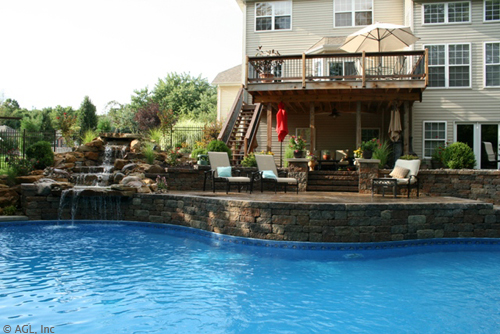 custom pool with waterfall and deck
