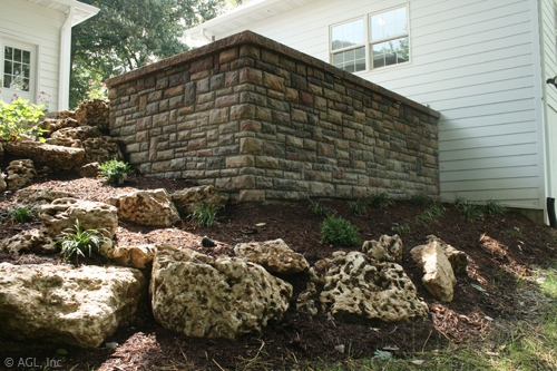 landscaped hill, stone brick wall,stone steps, boulders